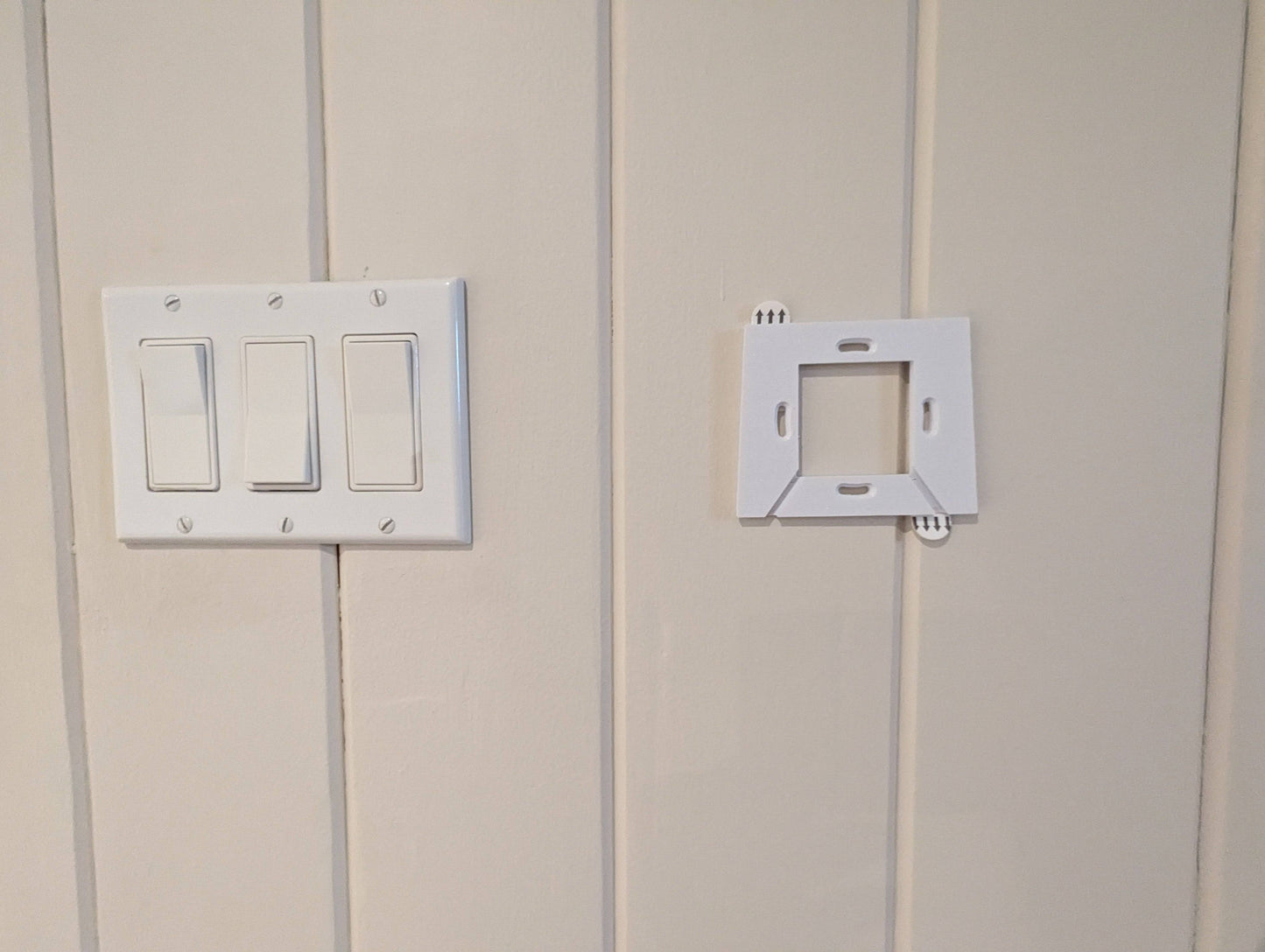 a light switch and outlet on a white wall