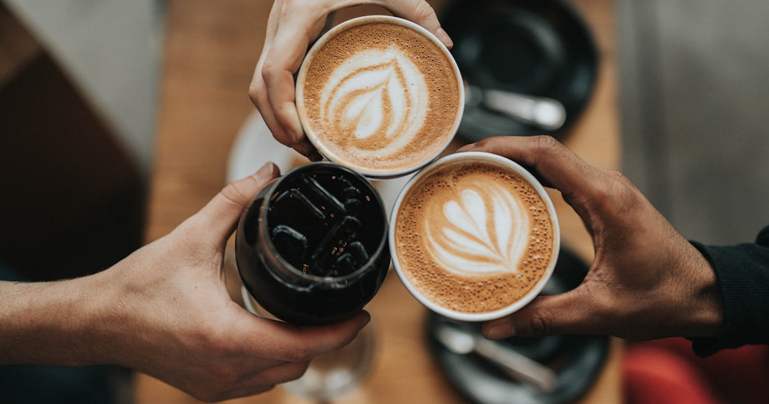 Espresso machine brewing coffee into a white cup