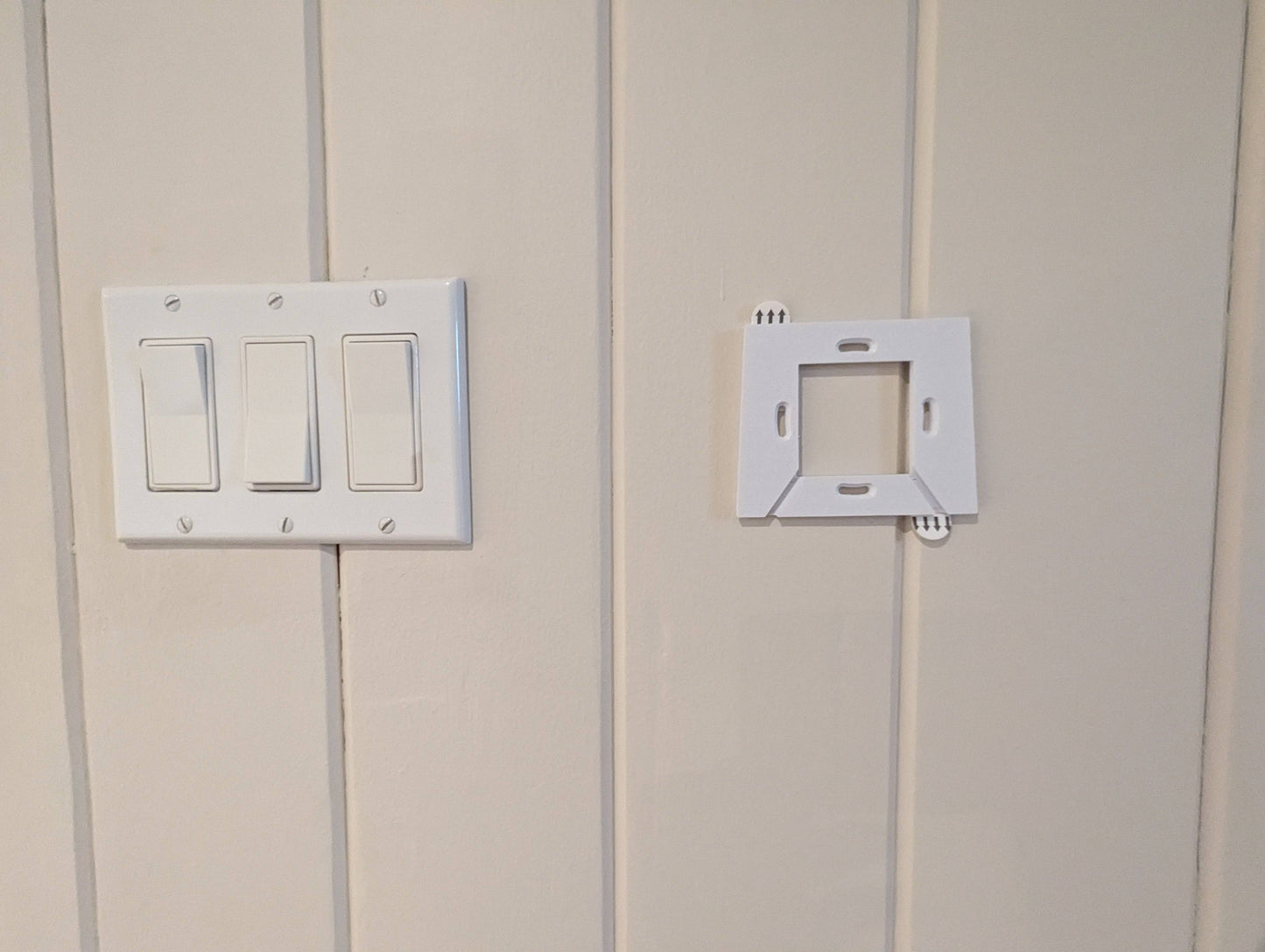 a light switch and outlet on a white wall