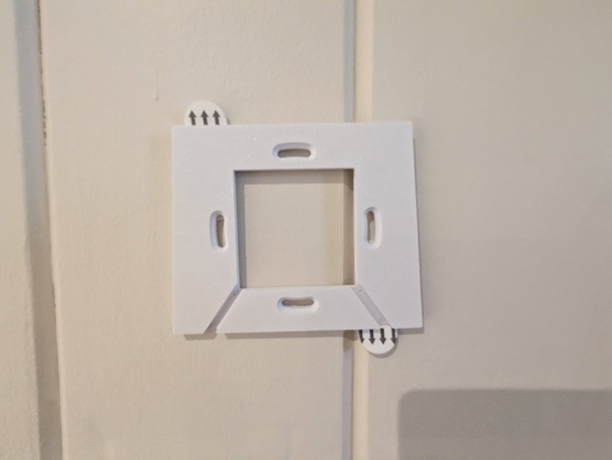 a white wall outlet on a white wall