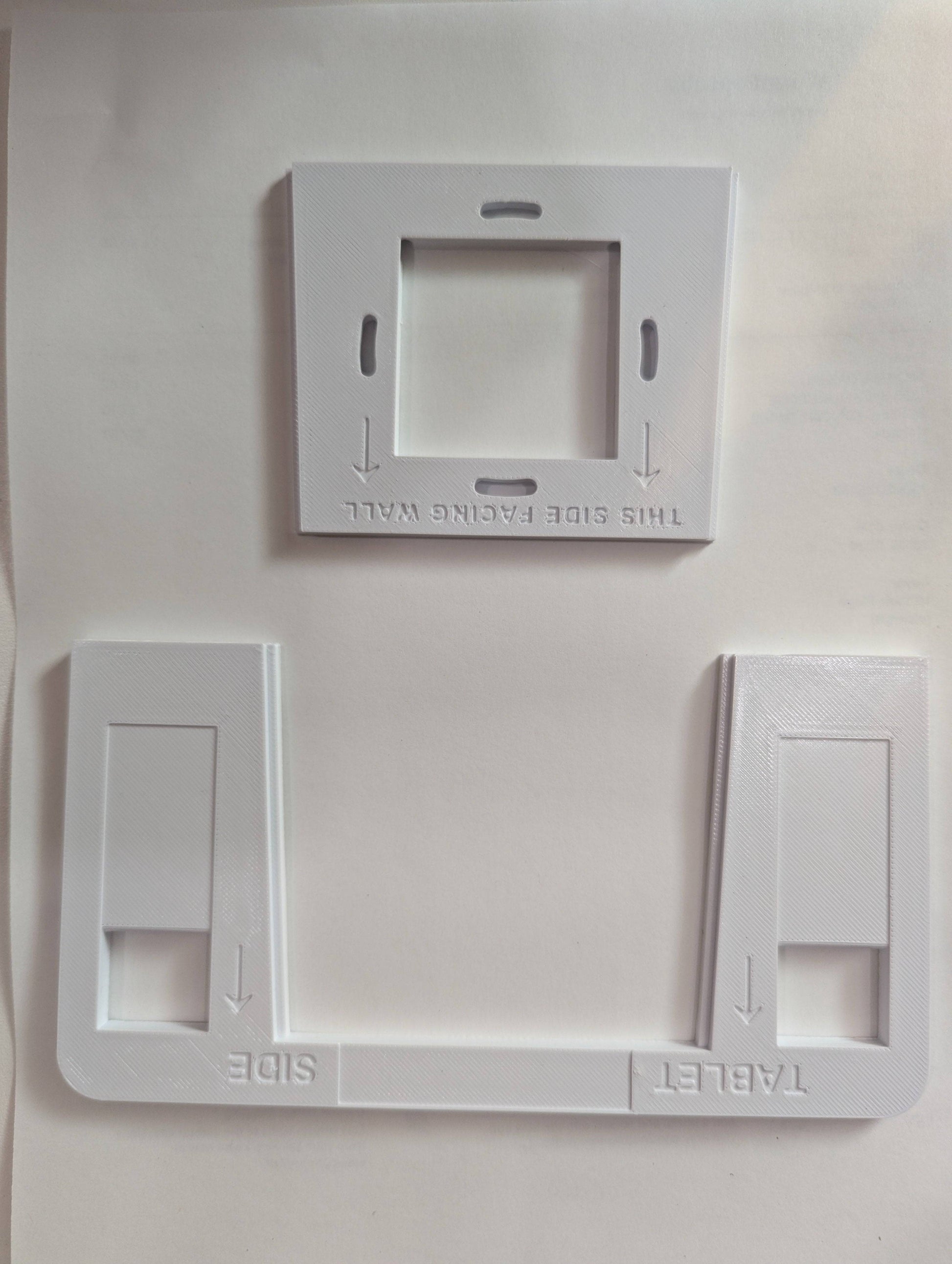 a couple of white switch plates sitting on top of a table