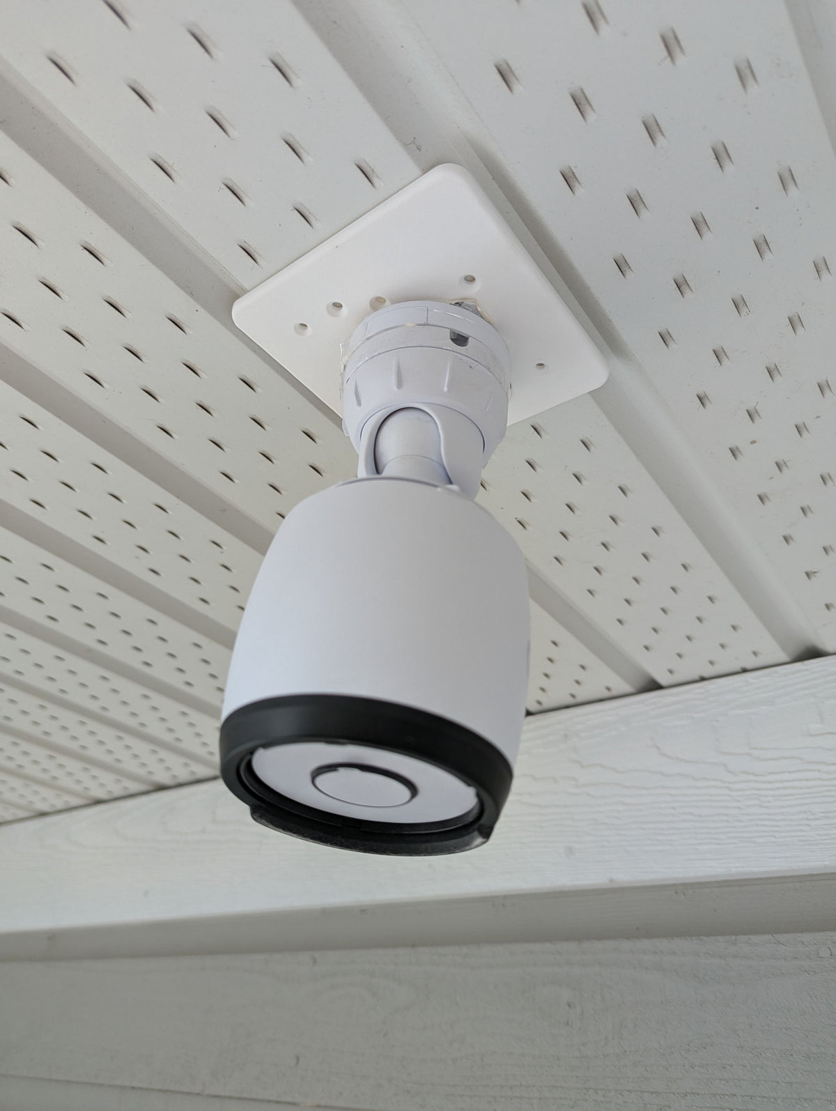 UniFi G6 Bullet camera mounted under a vented soffit with the square octagon-box adapter plate