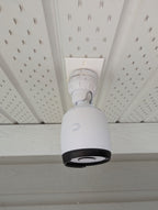 UniFi G6 Bullet camera mounted under a soffit on the white rectangular single-gang adapter plate