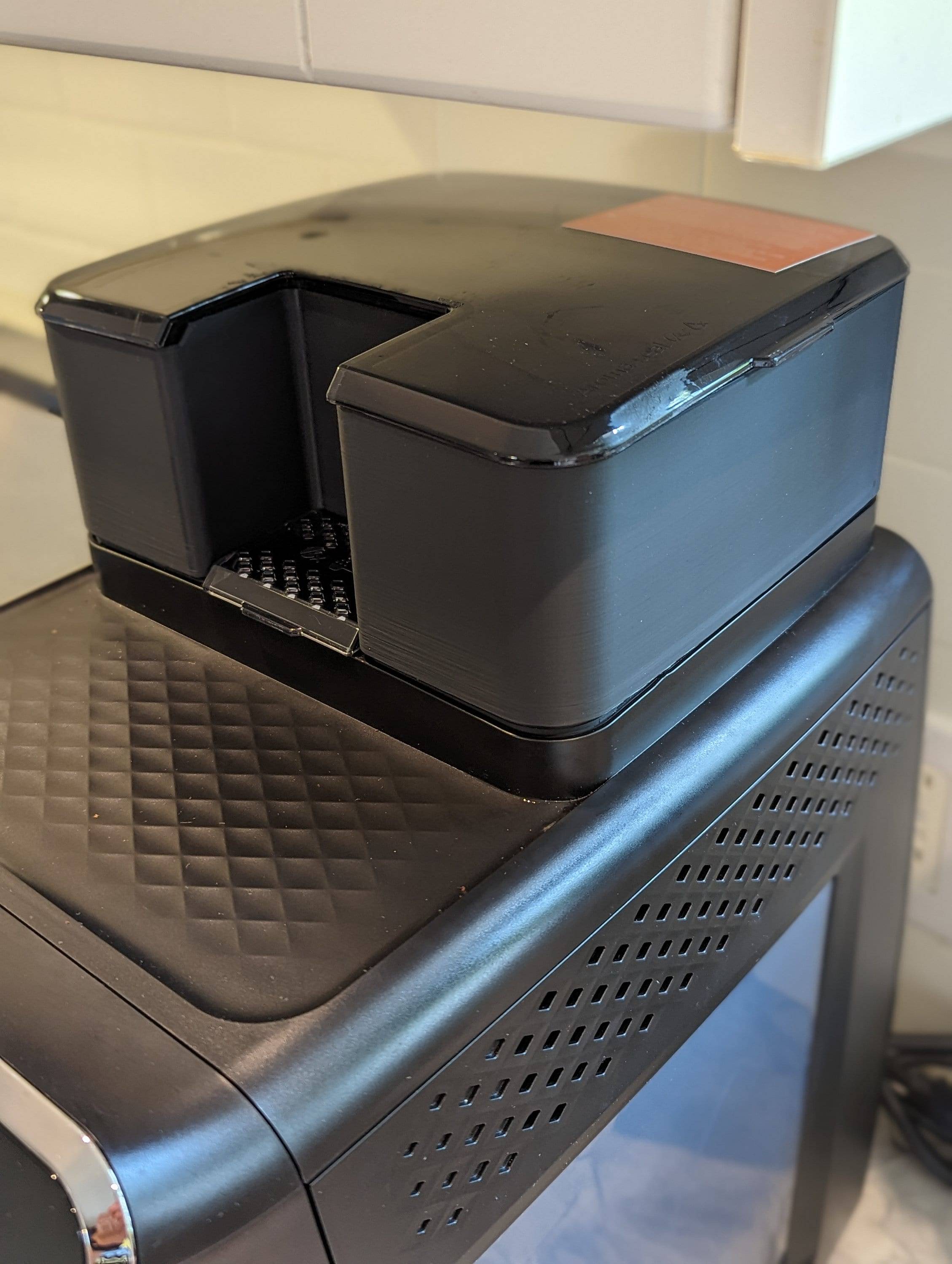 Close-up of a Philips coffee hopper with whole beans