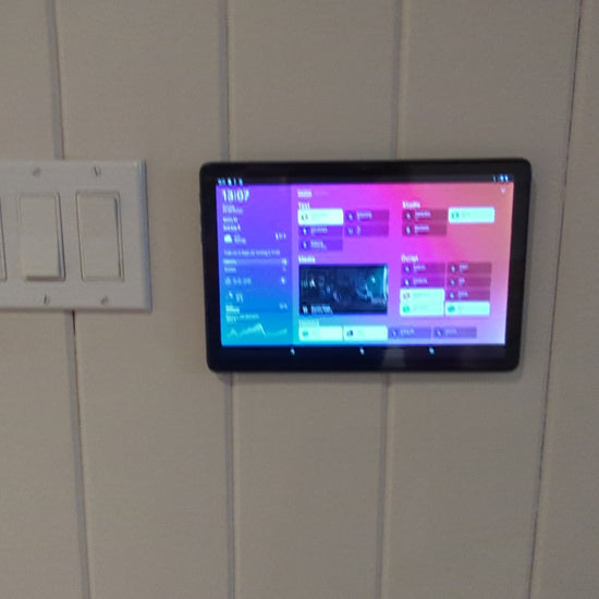 a tablet mounted to a wall in a bathroom