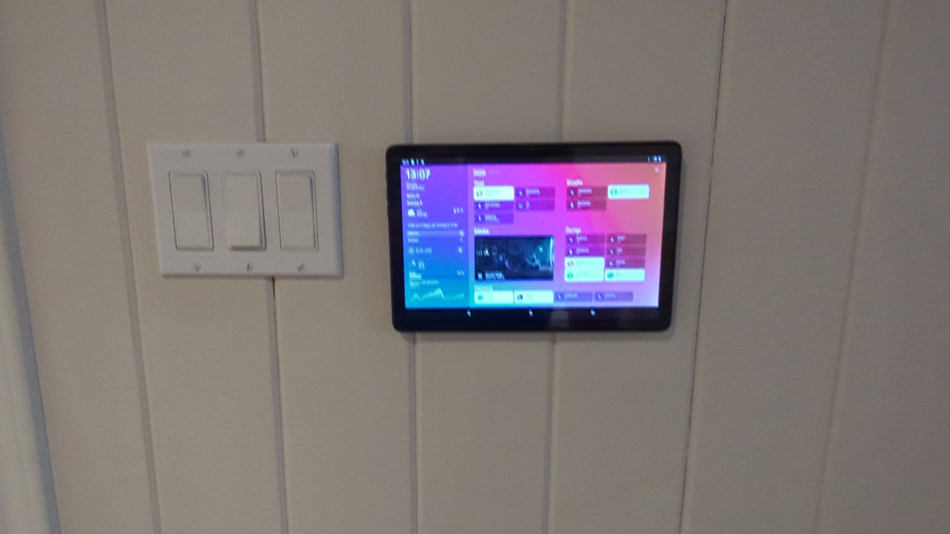 a tablet mounted to a wall in a bathroom